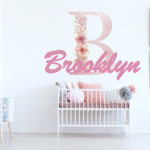 Custom floral monogram wall decal with personalized name Brooklyn in pink baby nursery